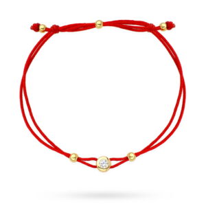 Bransoletka złote kółko z centralnym kamykiem na czerwonym sznurku